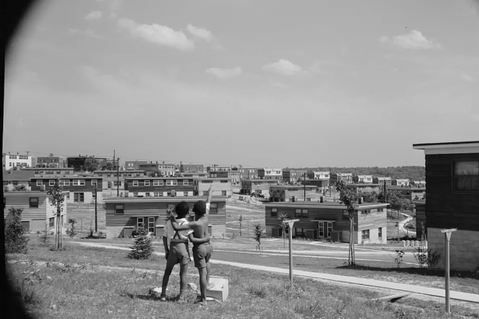 Black and white photo of two young boys standing on a hill overlooking the Frederick Douglass housing project in Anacostia, D.C.